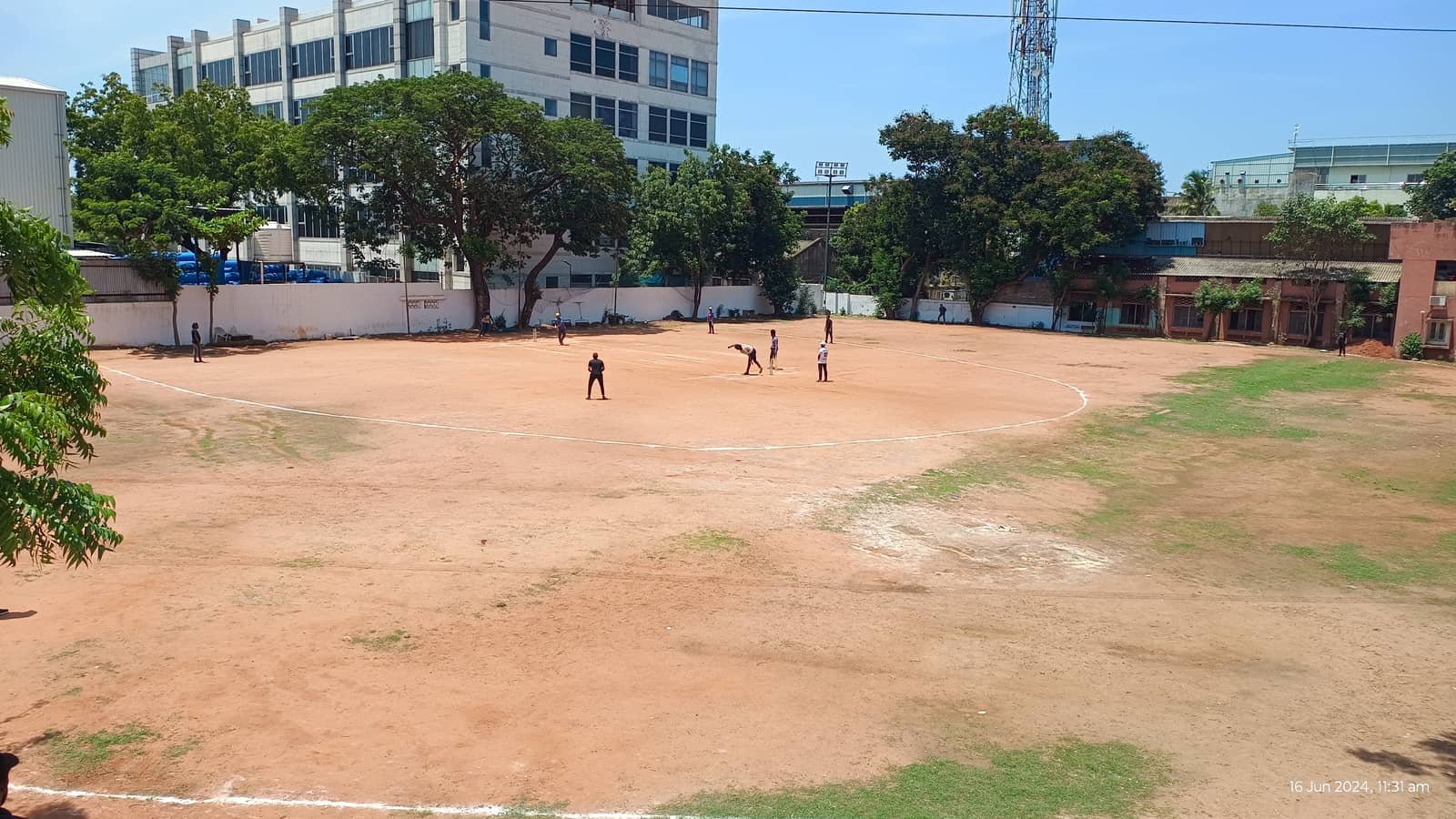 Full outdoor cricket ground with marked boundary and a match in progress at 5rings Sports, Ambattur Industrial Estate